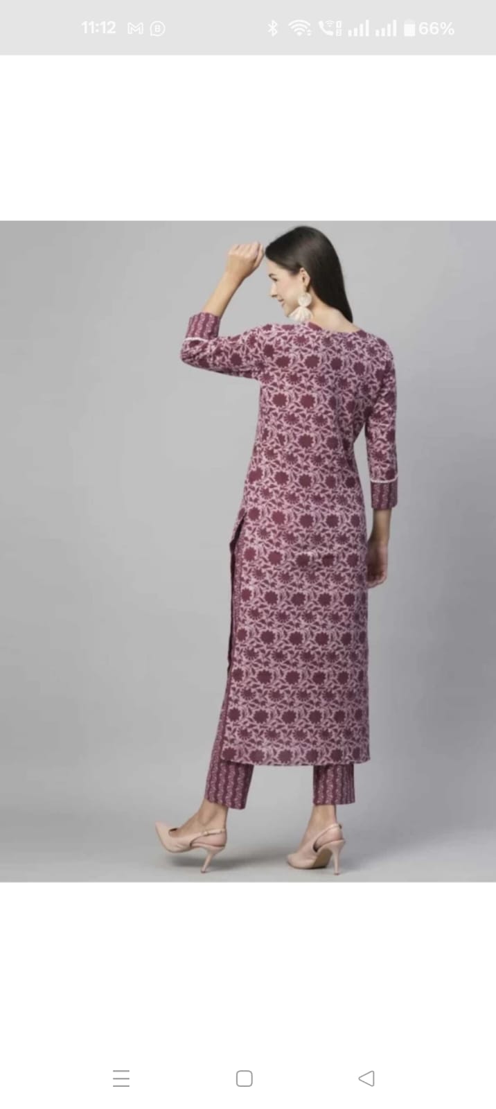 Woman wearing pink floral print cotton kurta and pant combo online with side slits and three-quarter sleeves