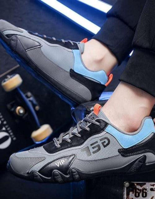 Dropdash men's stylish running shoes in gray and black with blue accents worn with black pants