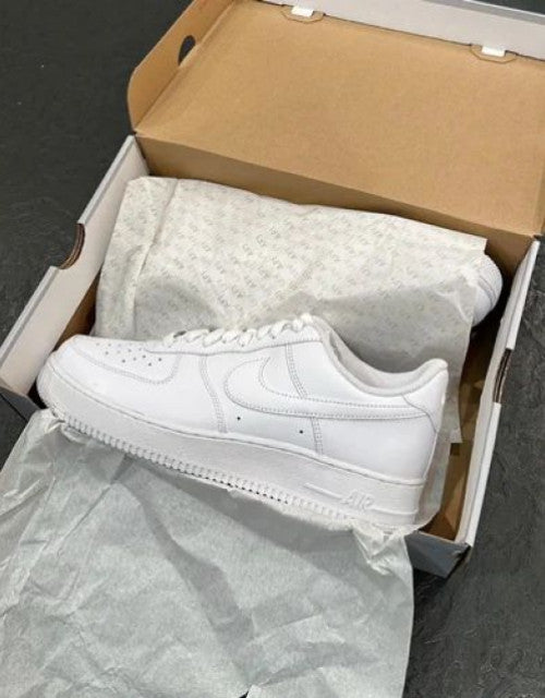 White Nike Air Force 1 sneaker in box illustrating lightweight men's walking footwear style