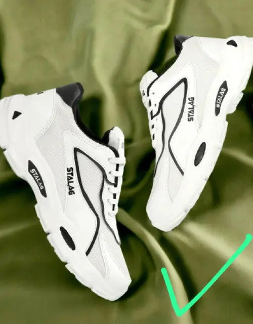 QuickGadgets white stylish sports shoes for men with black accents on green background