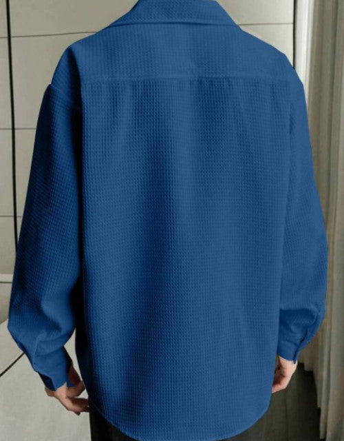 Back view of person in blue textured oversized shirt paired with black Dropdash TrackPants