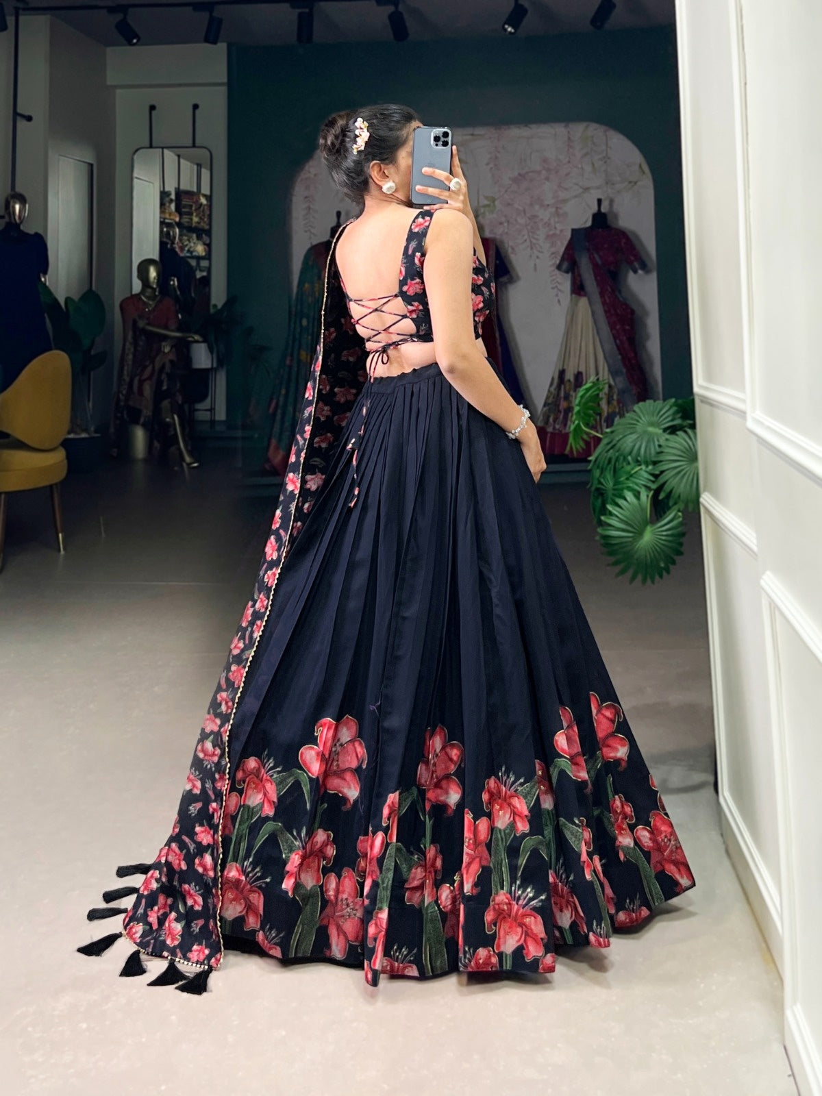 Back view of designer lehenga choli for women with black floral skirt and lace-up blouse