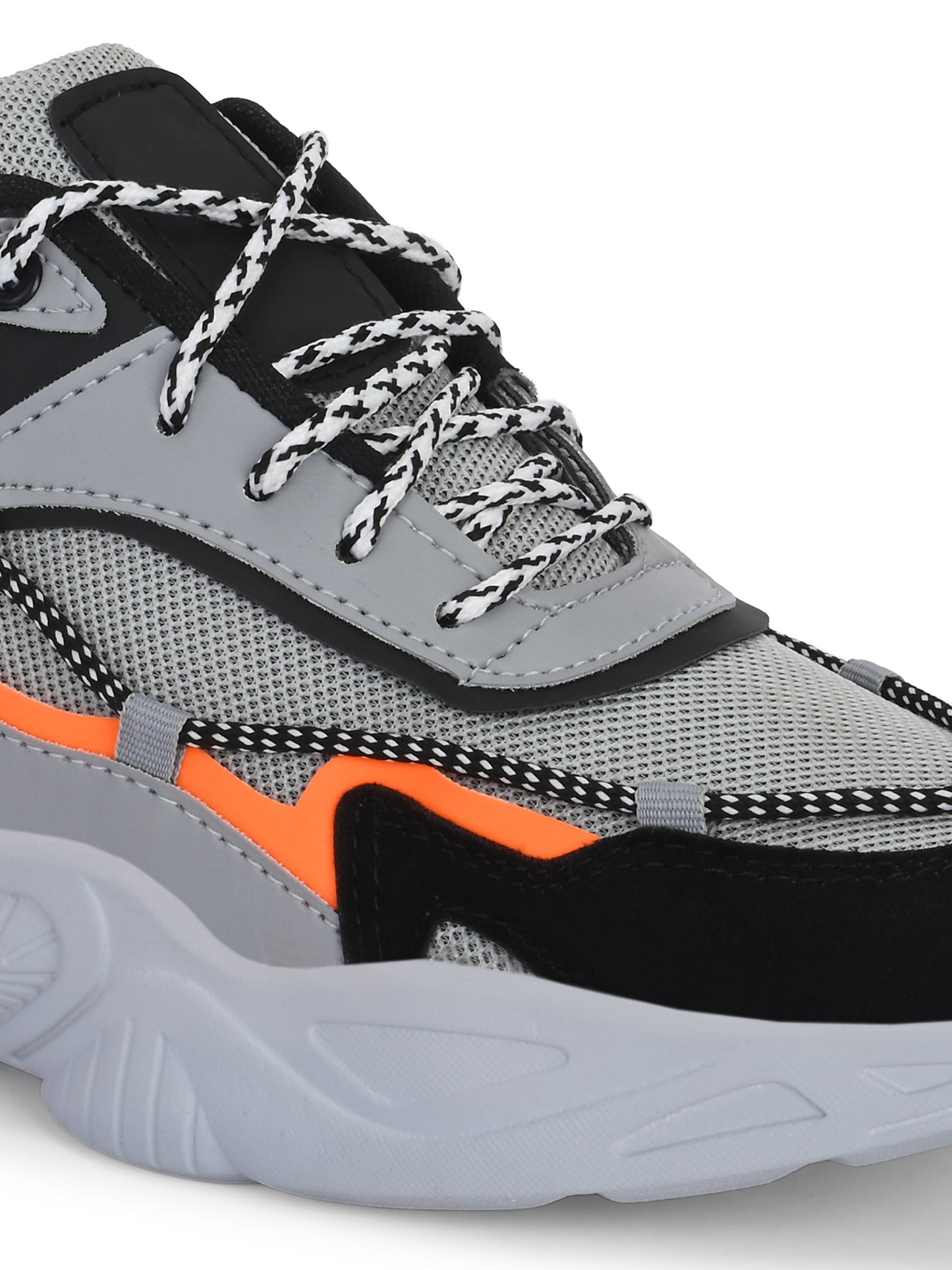 Close-up of grey sports shoes for men with black and orange accents and textured sole