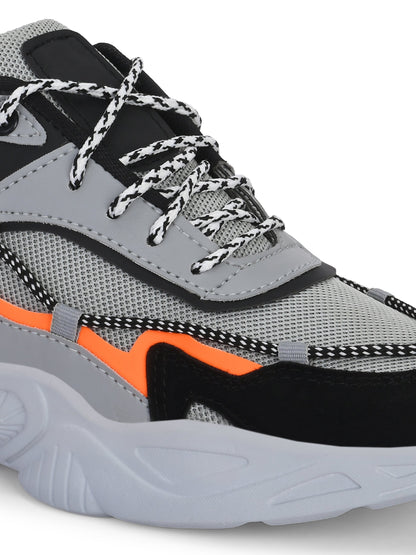 Close-up of grey sports shoes for men with black and orange accents and textured sole
