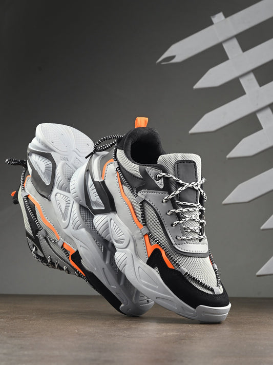 Grey sports shoes for men with black and orange accents and cushioned soles for comfort