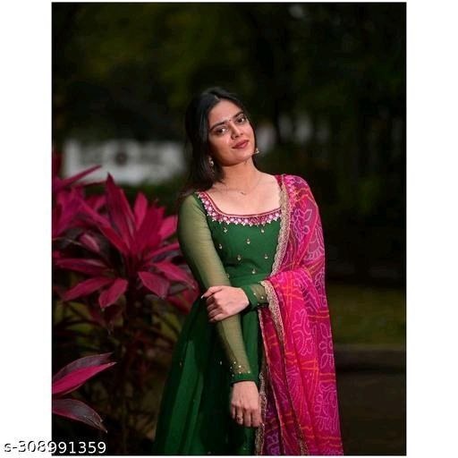 Woman wearing a green and pink long kurti for wedding and parties with intricate embroidery and sheer sleeves