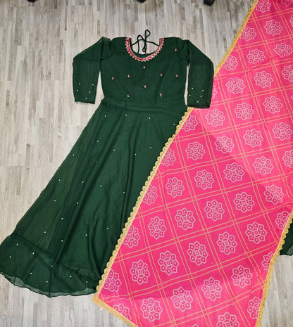 Green women's gown paired with pink dupatta featuring gold border long kurti for wedding and parties