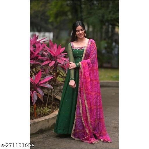 Woman wearing a green womens gown paired with a pink dupatta long kurti for wedding and parties