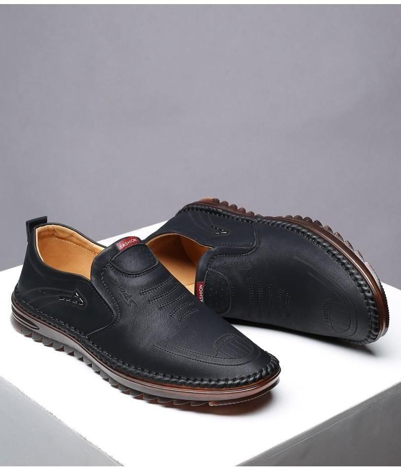 Black men leather casual shoes with slip-on design and stitched brown sole