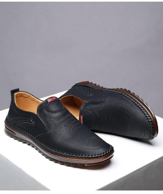 Black men leather casual shoes with slip-on design and stitched brown sole