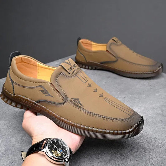 Brown men's laser cut loafers with detailed stitching and comfortable sole for casual wear