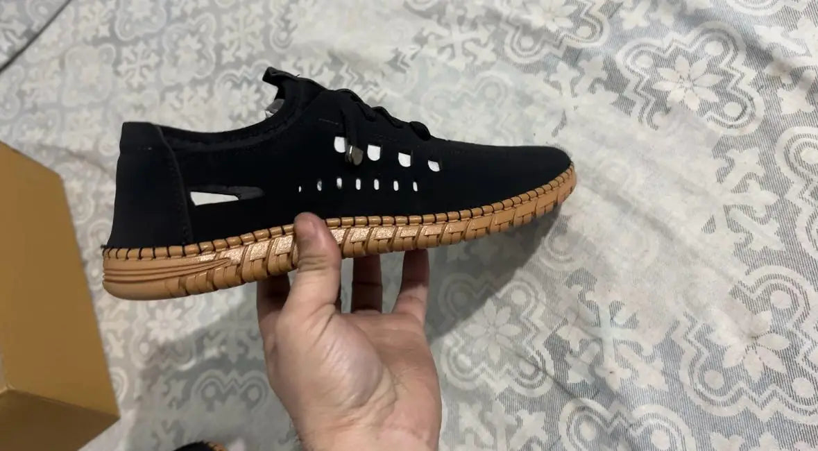 Black casual men's shoe with brown sole designed as premium men's fashion shoes