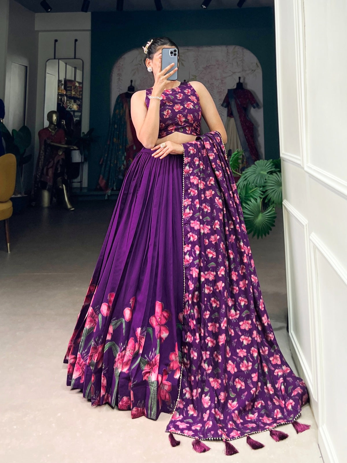 Woman wearing premium quality designer lehenga in purple with floral patterns and matching dupatta