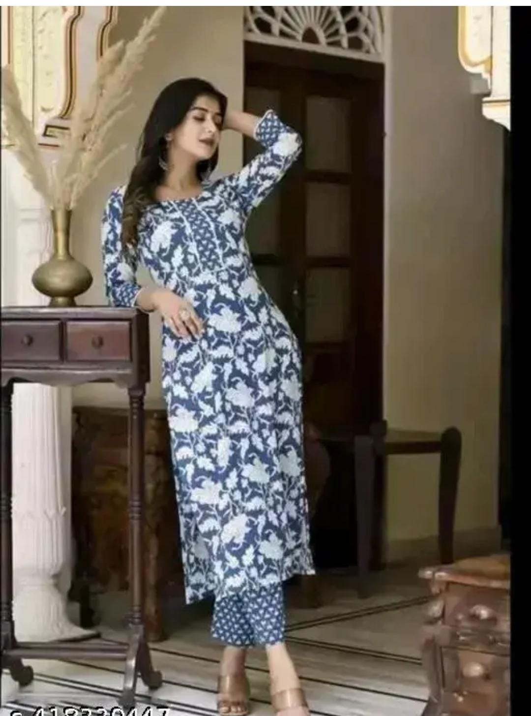 Woman wearing a premium quality kurti for women in blue and white floral print kurta set indoors