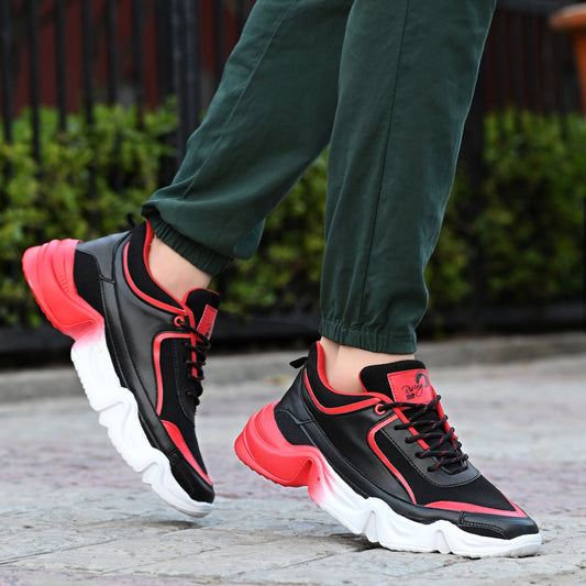 Black and red sports shoes for men with thick white soles worn with green pants outdoors
