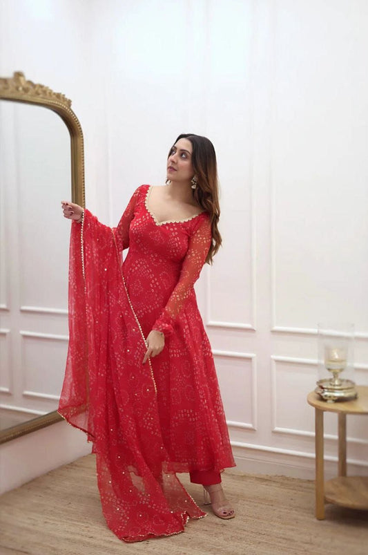 Elegant red bandhani gown for women with long sleeves and matching dupatta in a classic room