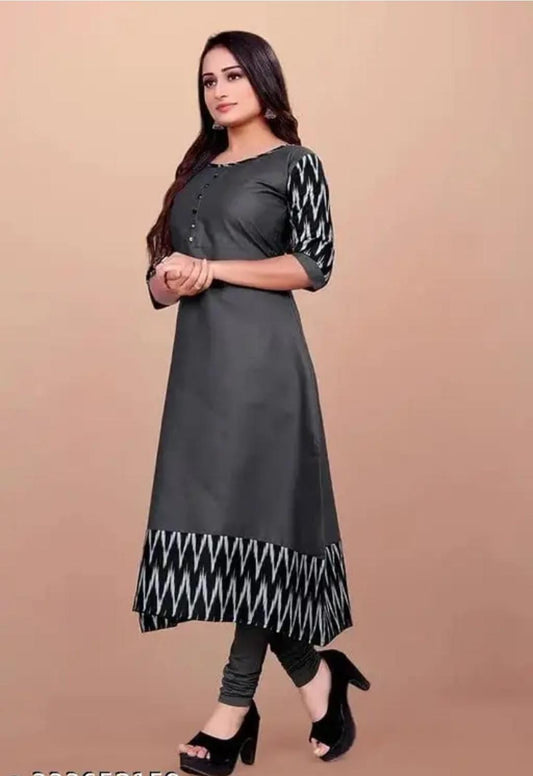 Elegant women's grey cotton gown with patterned sleeves and hem, styled with black heels